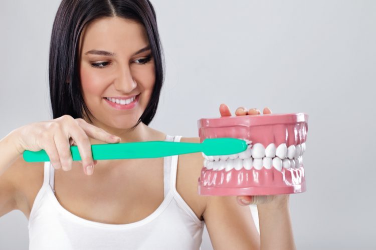 young woman with big toothbrush and jaws